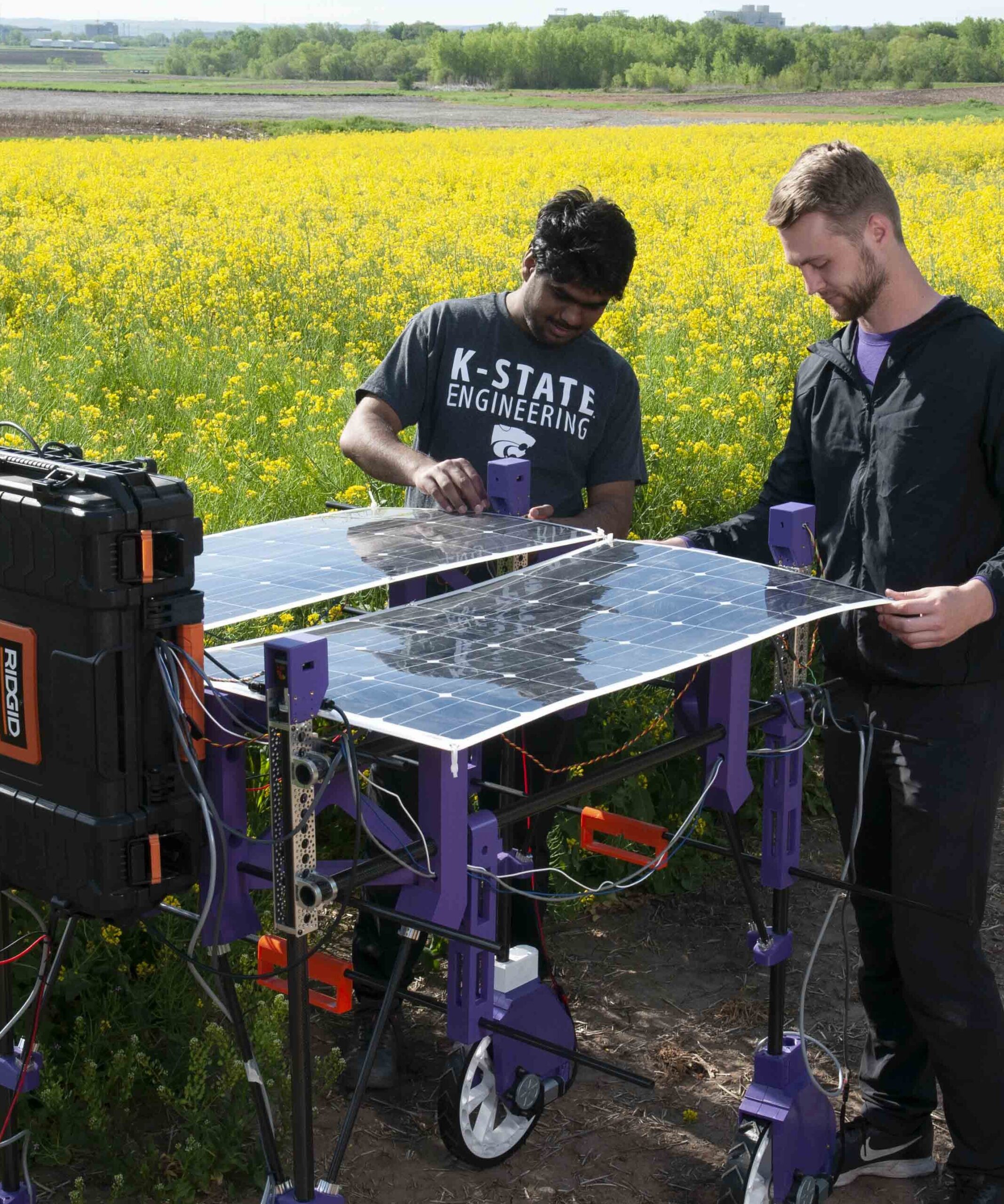 Two researchers working on a wheat phenotyping robot 